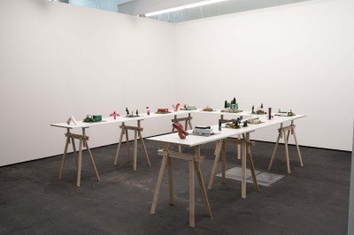A table in a white-walled room with objects.