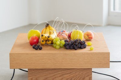 A group of fruits with wires connecting them.