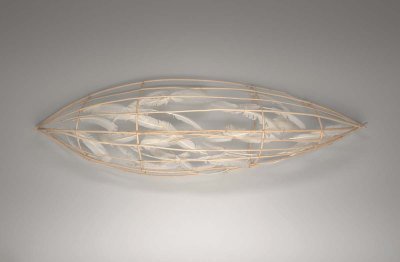 A wooden armature sculpted to resemble a canoe. The armature is filled with feathers.