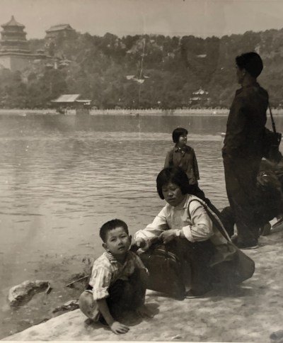 A little boy and a woman at the side of a river.