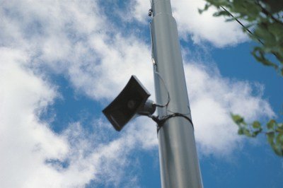 A mega-speaker mounted to a tall pole.